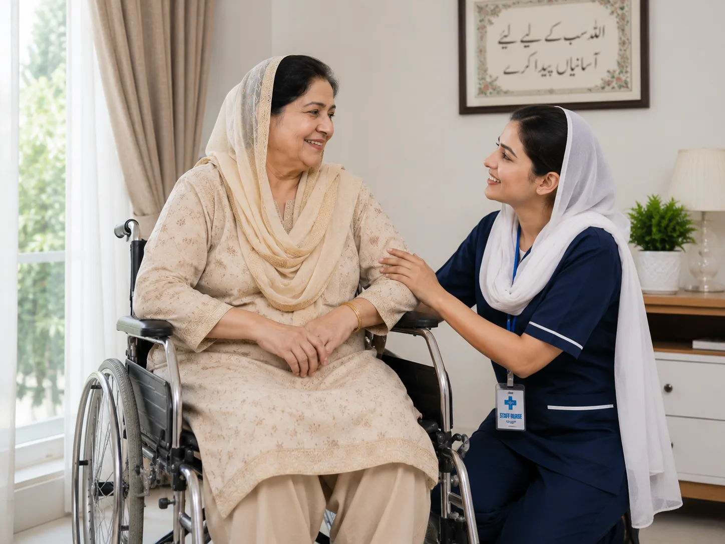Nurse in navy blue scrubs with white headscarf comforting an elderly woman in a wheelchair at home